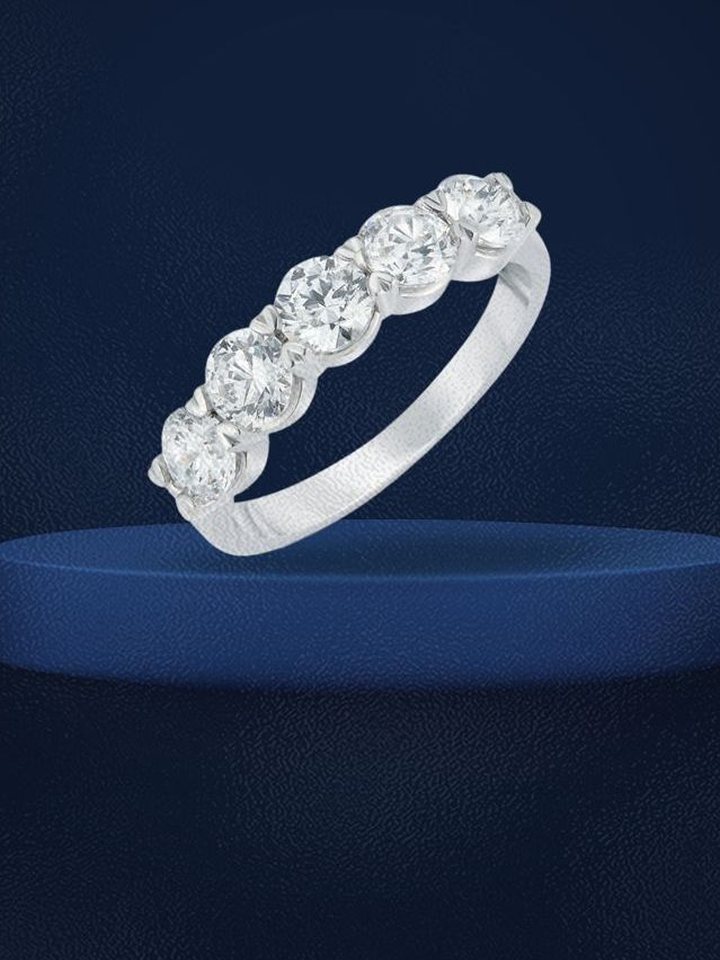 Five-stone diamond band on a navy podium
